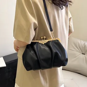 Elegant black pleated shell bag with a gold flower metal clasp and thin shoulder strap