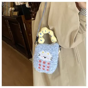 Close-up of cute blue plush cat crossbody bag with woven strap worn on a trench coat