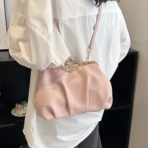 Pink pleated shell shoulder bag with sparkling rhinestone flower clasp and metal frame
