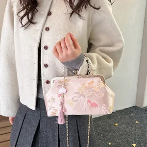 Elegant Chinese style pink shell bag with floral jacquard pattern and tassel detail