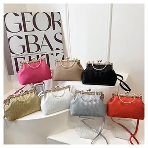 Collection of textured woven shell bags in seven colors featuring metal ring handles