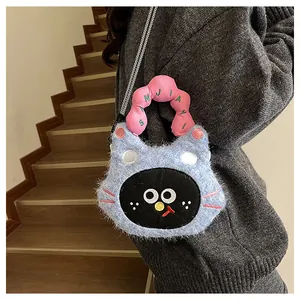 Detail of cute navy faux fur cat handbag with pink soft handle and woven strap on model