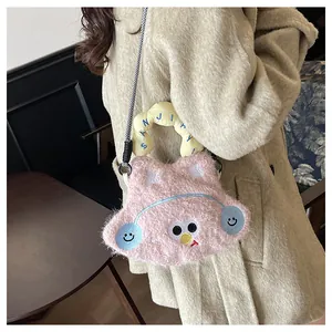 Detail of pink plush cartoon crossbody bag with embroidered face and rope strap
