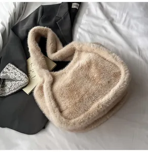 Close-up of fluffy faux fur tote bag in beige texture on a white bedding background