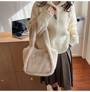 Detail of soft beige plush faux fur tote bag showing texture and large top handle