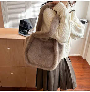 Close-up of fluffy brown plush tote bag showing soft faux fur texture and wide strap