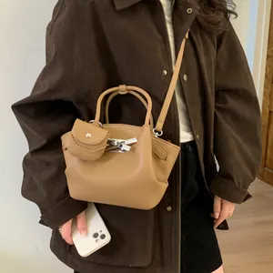Vintage camel lychee grain leather handbag with silver lock and mini charm pendant