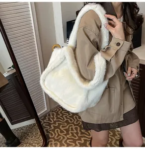 Detailed close-up of a large white faux fur tote bag showing soft plush texture and volume
