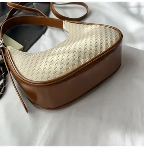Close-up of the woven texture and contrast leather detail on this stylish crescent bag