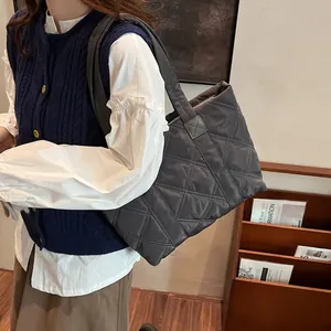 Deep grey quilted puffer tote bag with classic diamond stitching for casual winter style