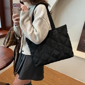 Chic black quilted puffer tote bag with rhombus stitching and comfortable shoulder strap