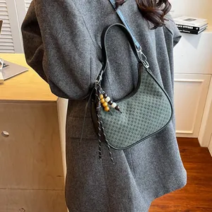 Dark green hobo shoulder bag with woven texture and colorful wooden bead charms