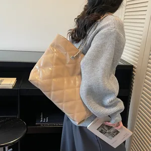Elegant quilted tote bag with metallic chain strap in beige textured faux leather