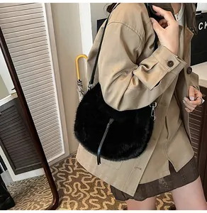Détail d'un sac à bandoulière en fausse fourrure noire avec sangle en cuir et crochets