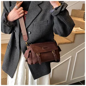 Brown frosted messenger bag with adjustable straps and wide fabric shoulder strap shown on model