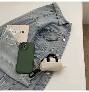Mini luggage charm bag and phone case set on denim jacket with a trendy aesthetic