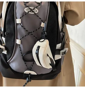 Detail of grey canvas backpack with side mesh pocket and detachable mini white pouch