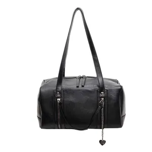 Classic black leather Boston bag with heart pendant and twin handles in a sleek design