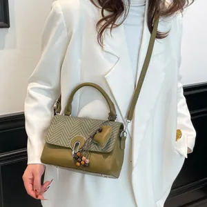 Retro dark green crossbody bag with herringbone woven flap and beaded heart charm