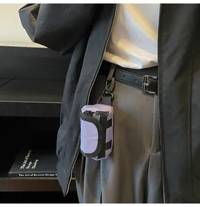 Mini lavender canvas bag with zipper and carabiner shown hanging on a waist belt loop