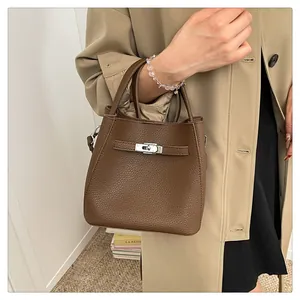 Detailed view of deep brown lychee grain leather bucket bag with silver metal swivel lock