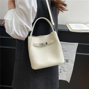 Classic cream litchi texture bucket bag with silver twist lock and adjustable strap