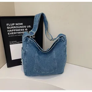 Detailed macro view showing washed denim fabric texture and adjustable strap buckle