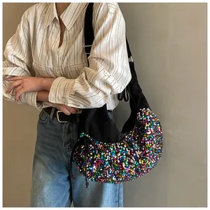 Detailed close-up of a crescent crossbody bag featuring colorful sequins and drawstring detail