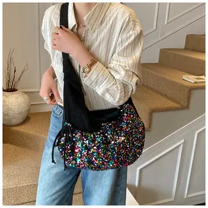 Colorful sequin hobo bag shown on model with adjustable strap for a stylish spring look