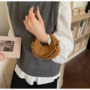 Vue détaillée du sac demi-lune marron avec chaîne dorée épaisse au style chic français