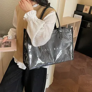 Minimalist black Tyvek tote bag with white TOTE BAG lettering in a cozy indoor setting