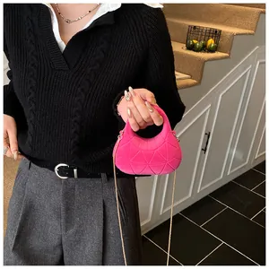 Detail view of mini rose pink velvet handbag with geometric quilting and gold chain strap
