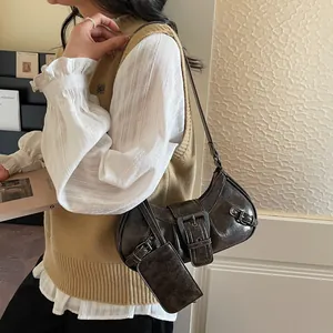 Retro dark brown underarm bag with belt buckle details and small detachable pouch
