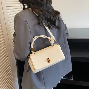 Chic off-white lychee texture handbag with knotted handle and gold metal twist lock