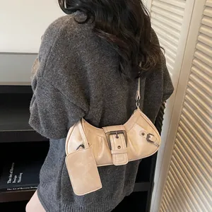 Retro cream white underarm bag with belt detail and mini pouch on grey sweater model