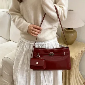 Deep red patent leather underarm shoulder bag with silver buckle and mirror-like finish
