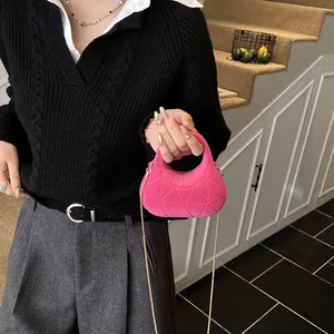 Rose pink suede mini crossbody bag with geometric quilting and gold chain strap