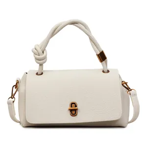 Minimalist off-white pebbled leather handbag with gold twist lock and knotted handle