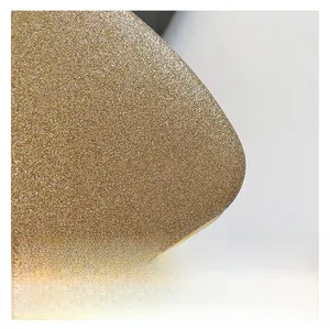 Detailed macro view of premium golden sequin fabric with fine metallic trim on handbag