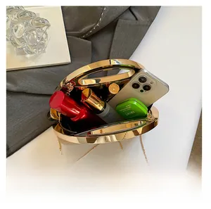 Interior storage of a gold hardshell evening clutch with phone and cosmetics