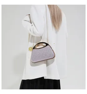 Detail of purple sequin evening bag with gold ring handle worn with a white blazer