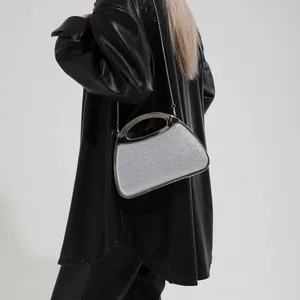 Elegant silver sequin evening clutch bag with metal handle and detachable chain strap