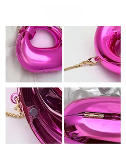 Detail of rose red mirror surface crescent bag with gold chain and magnetic closure