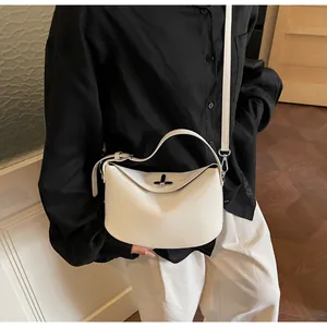 Minimalist creamy white crescent bag with silver metallic twist lock and smooth texture