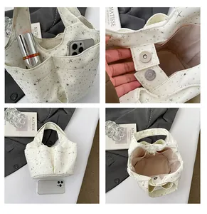 Vista dettagliata della borsa tote in tela multitasche con chiusura magnetica