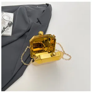 Top view of gold octagonal evening bag with a metallic mirror finish and chain strap