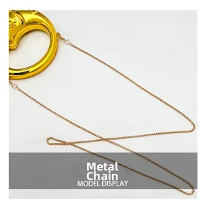 Close-up of the elegant gold metal chain and handle connector of the crescent bag