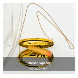 Internal capacity of mini gold metal crescent bag shown with a lipstick inside