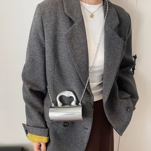 Silver mirror cylinder mini bag with sleek handle and chain strap on a model