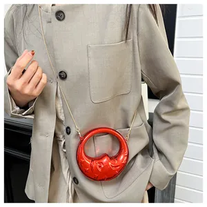 Detailed close-up of a red metallic crescent bag with star and moon embossed patterns